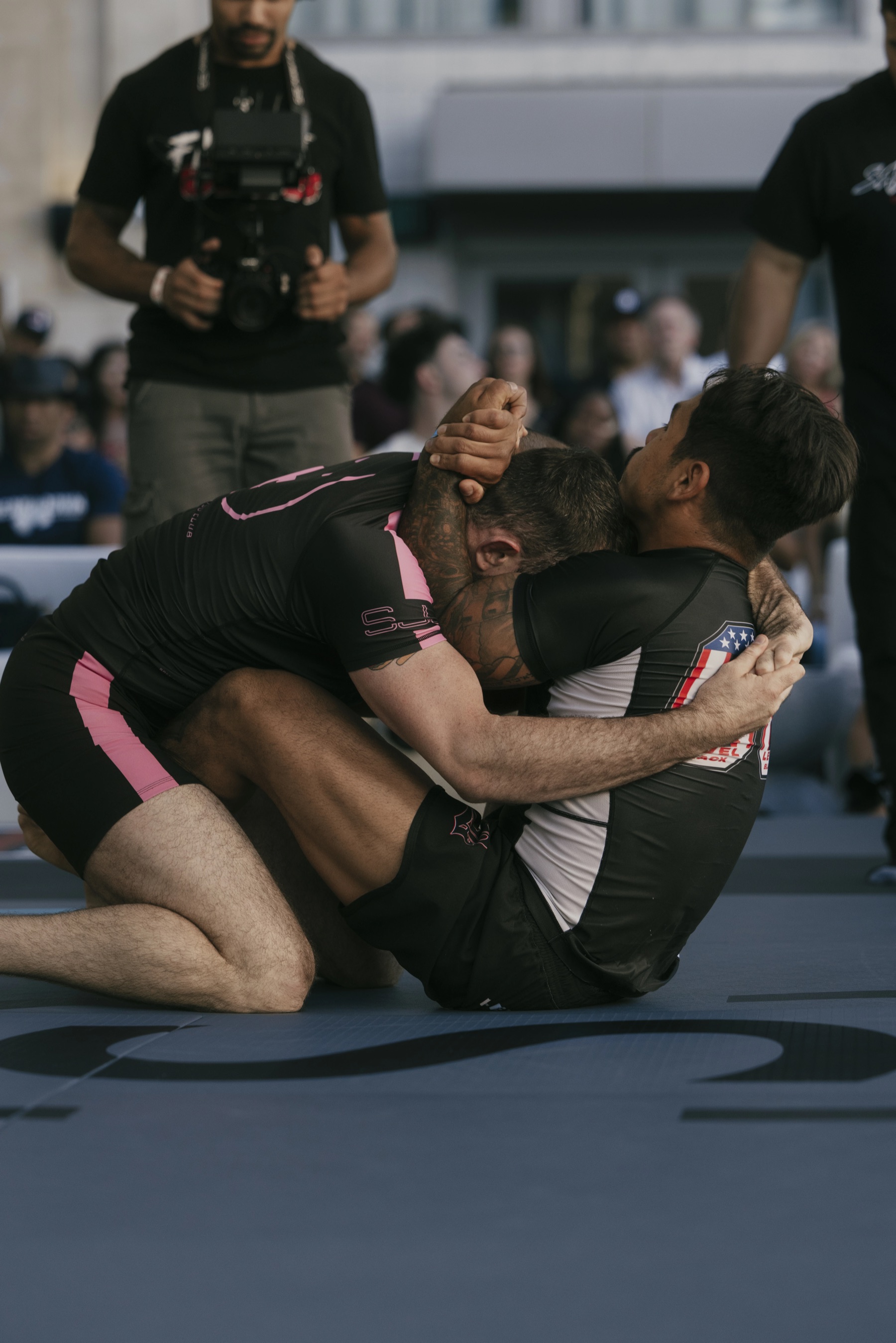Peerless Jiu Jitsu athletes grappling on the mat at a Brazilian Jiu Jitsu competition — Corona, CA