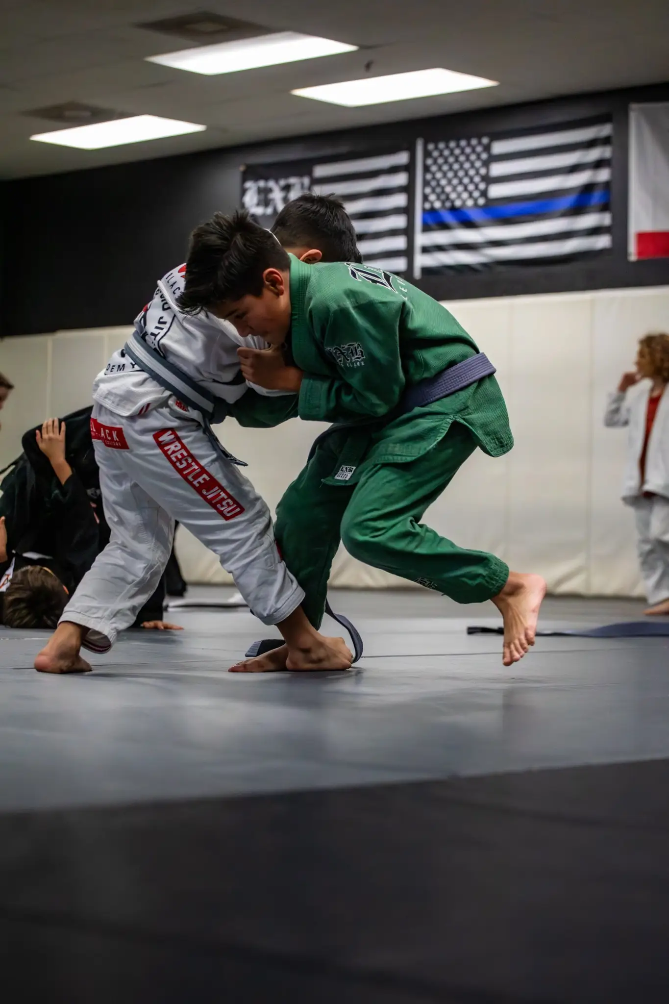 Youth Jiu Jitsu athletes working a standing takedown at Peerless in Corona, CA